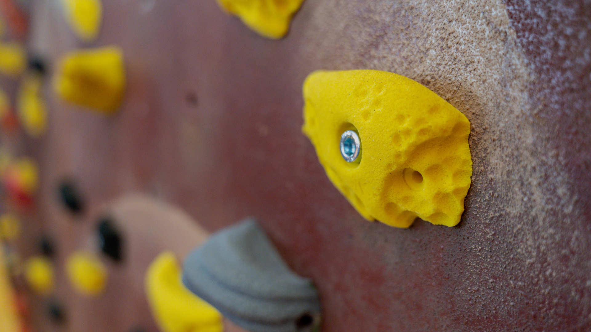 Rock climber reaching for a hold on a challenging route
