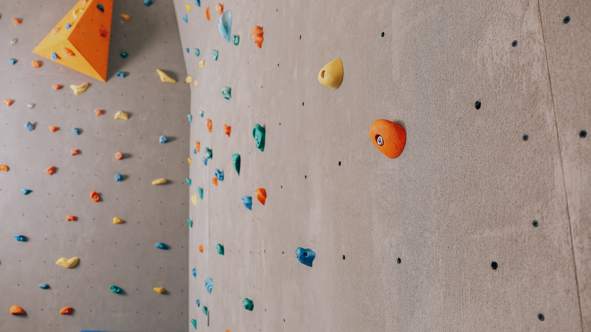 Expert climber testing new hold designs in outdoor setting